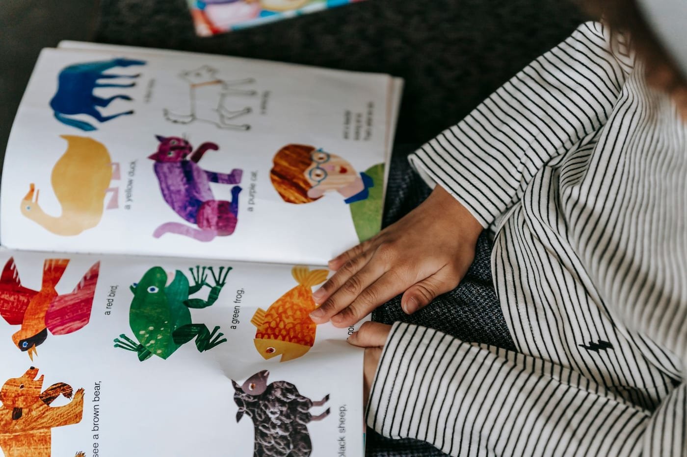A child reading a colorful picture book